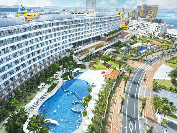 The facade of Hilton Okinawa Chatan Resort opens onto a tropical oasis of pools, palm trees and sea views.