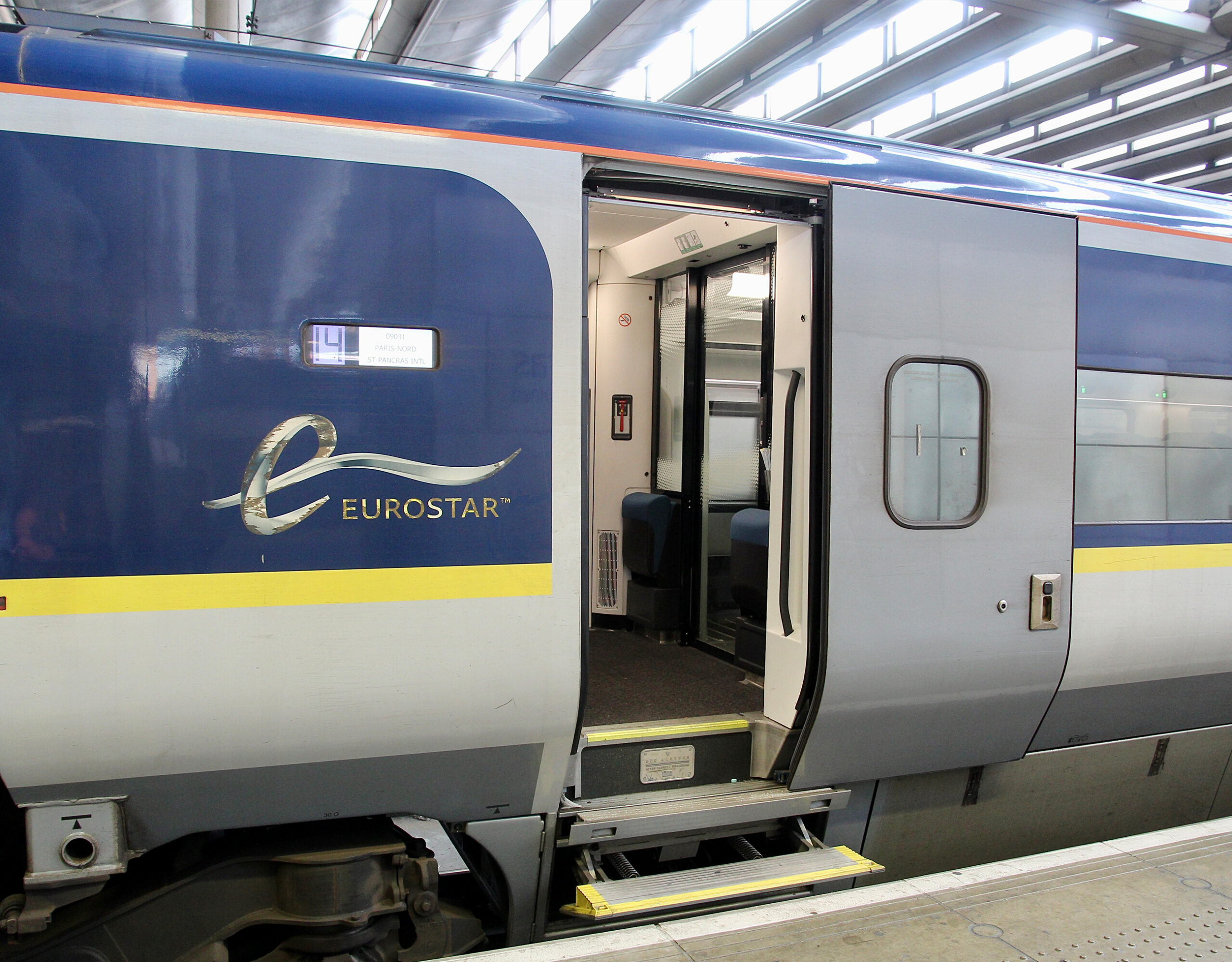 A blue Eurostar train with a door open